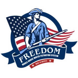 A patriotic logo featuring a man in a blue Revolutionary-style coat holding a rifle, set against an American flag and ribbon banner with the word 'FREEDOM' and smaller text reading 'Wholesale Water Filtration System' and 'Made in America.'.